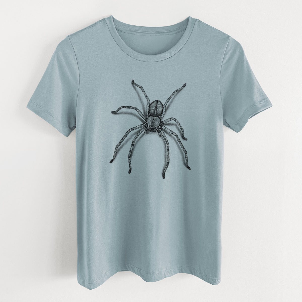 Vintage denim women's relaxed fit cotton t-shirt laid flat, printed with a detailed black ink illustration of a huntsman spider with long legs spread.