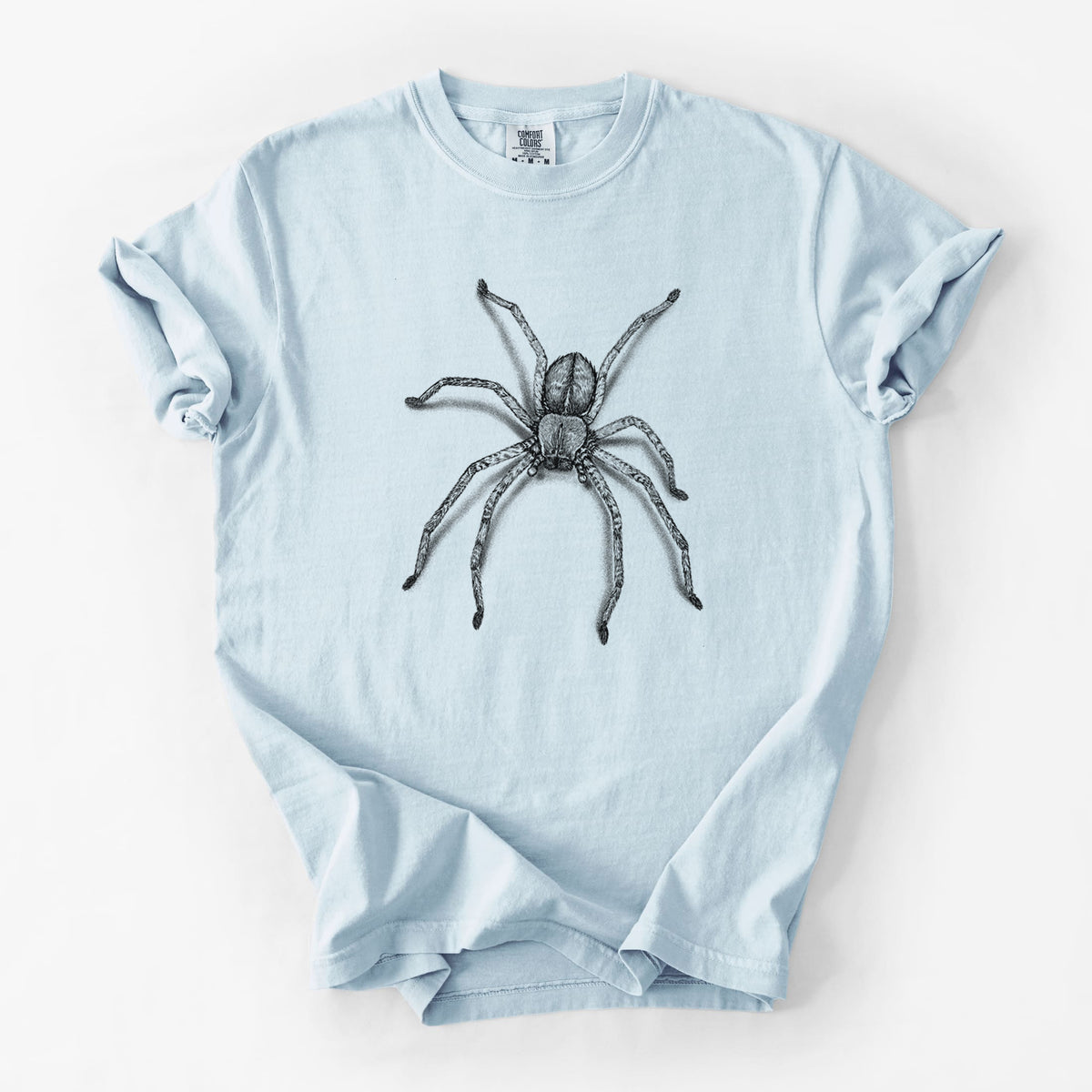 Chambray blue Comfort Colors t-shirt laid flat, printed with a detailed black ink illustration of a huntsman spider with long legs spread.