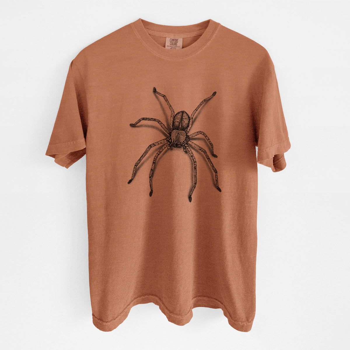Yam burnt orange Comfort Colors t-shirt laid flat, printed with a detailed black ink illustration of a huntsman spider with long legs spread.