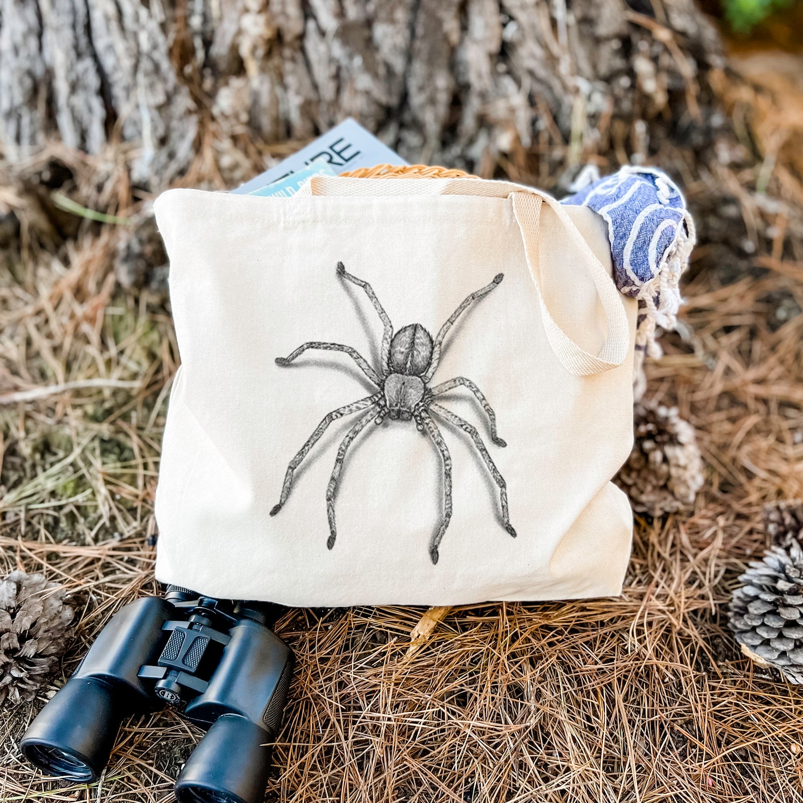 Natural canvas tote bag printed with a detailed black ink illustration of a huntsman spider with long legs spread.