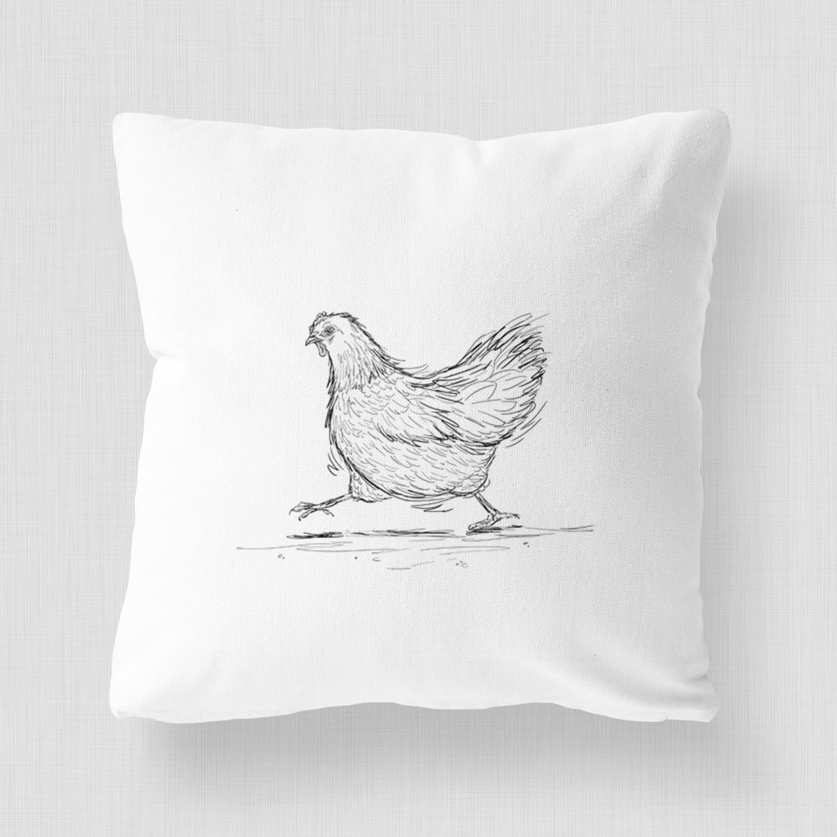 White pillow cover printed with a black ink sketch of a hen hurrying along.