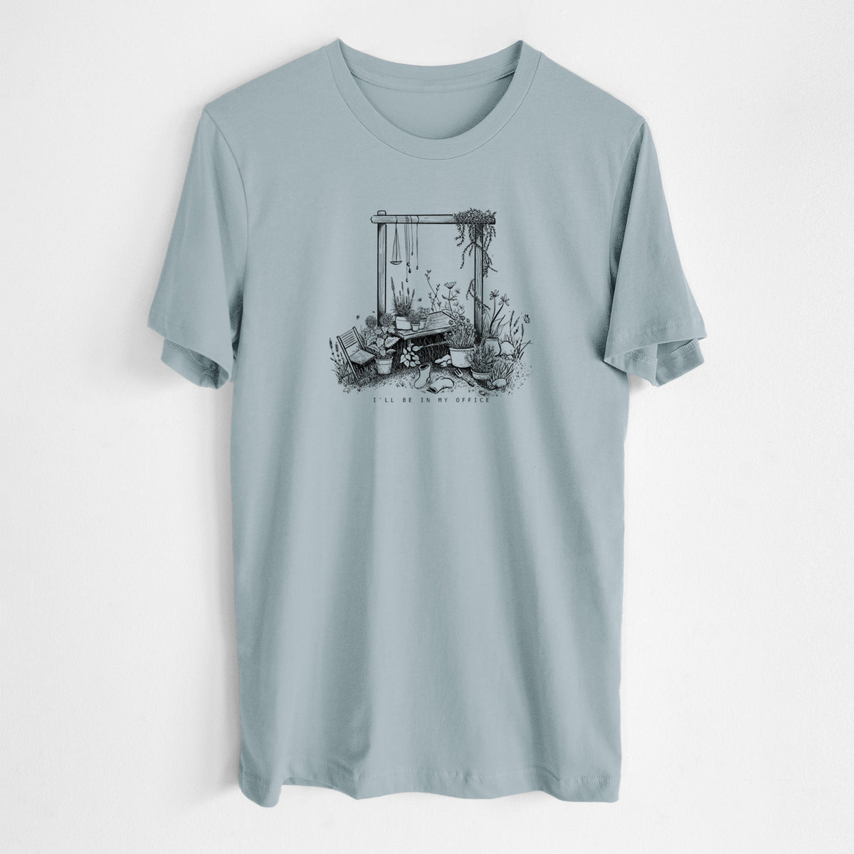 Vintage denim lightweight cotton t-shirt laid flat, printed with a black ink illustration of a garden gate arch surrounded by potted plants and flowers.