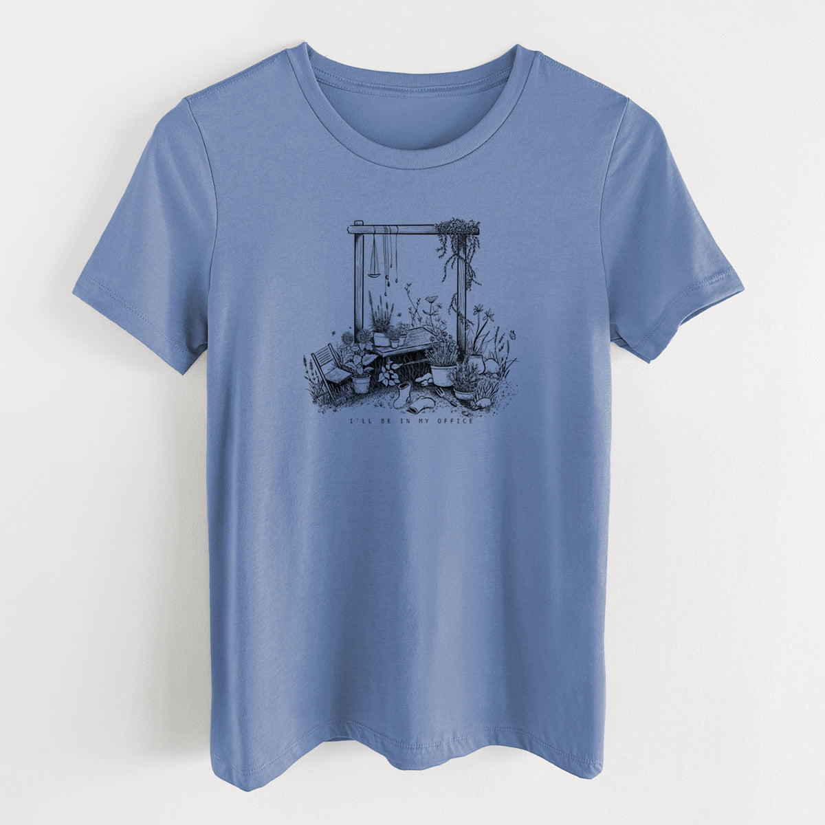 Blue bell women's relaxed fit cotton t-shirt laid flat, printed with a black ink illustration of a garden gate arch surrounded by potted plants and flowers.