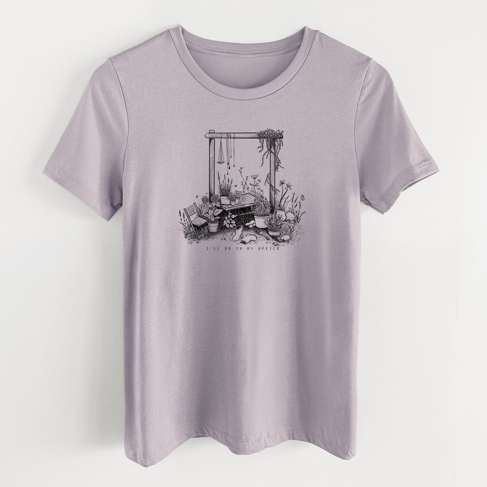 Light violet women's relaxed fit cotton t-shirt laid flat, printed with a black ink illustration of a garden gate arch surrounded by potted plants and flowers.