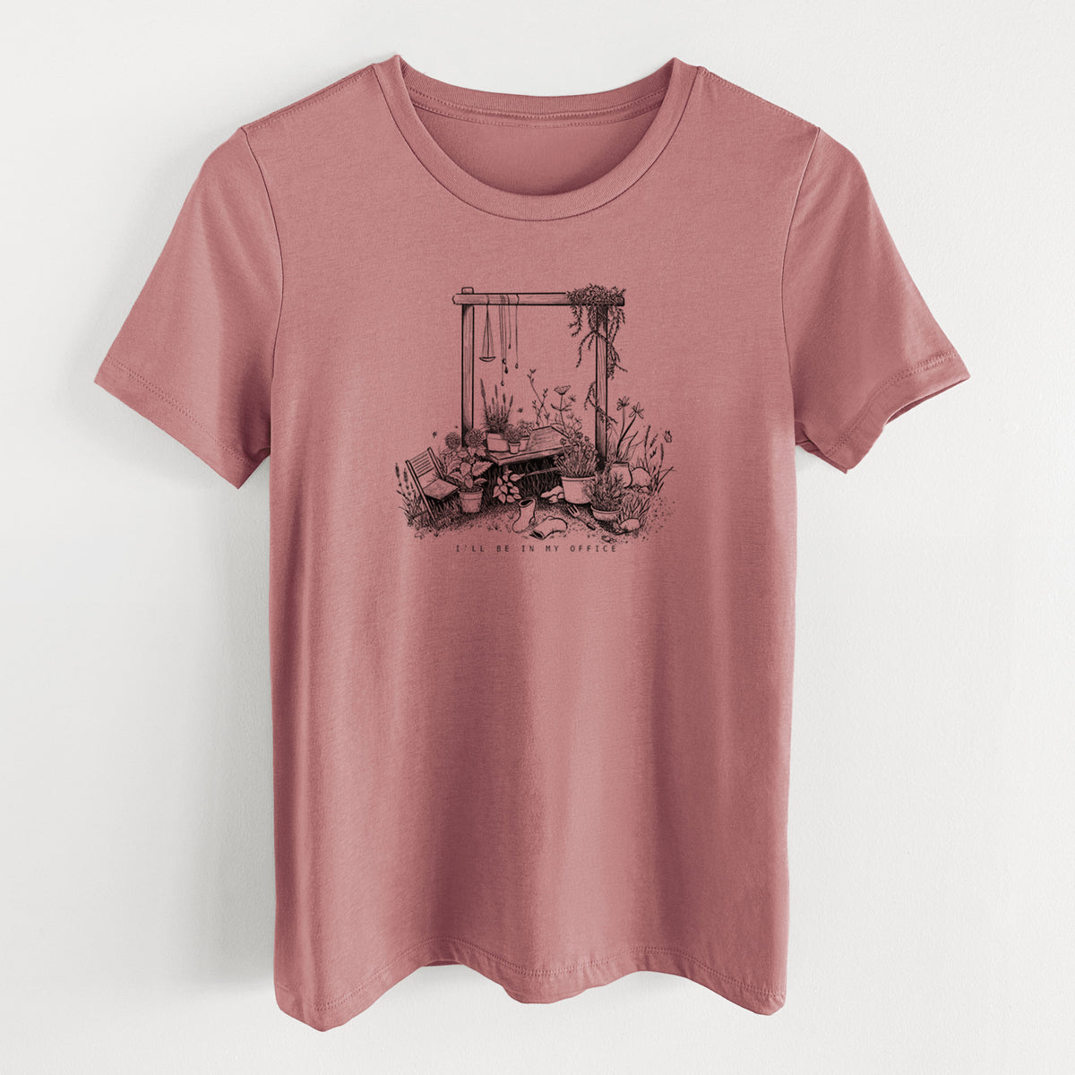Mauve pink women's relaxed fit cotton t-shirt laid flat, printed with a black ink illustration of a garden gate arch surrounded by potted plants and flowers.