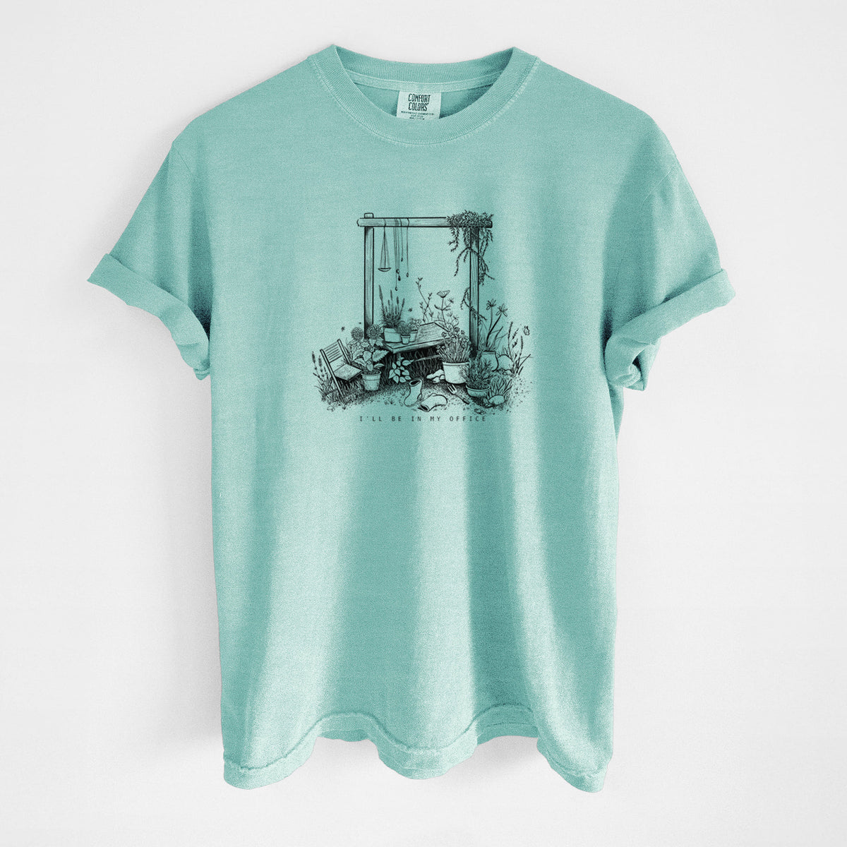 Chalky mint Comfort Colors t-shirt laid flat, printed with a black ink illustration of a garden gate arch surrounded by potted plants and flowers.