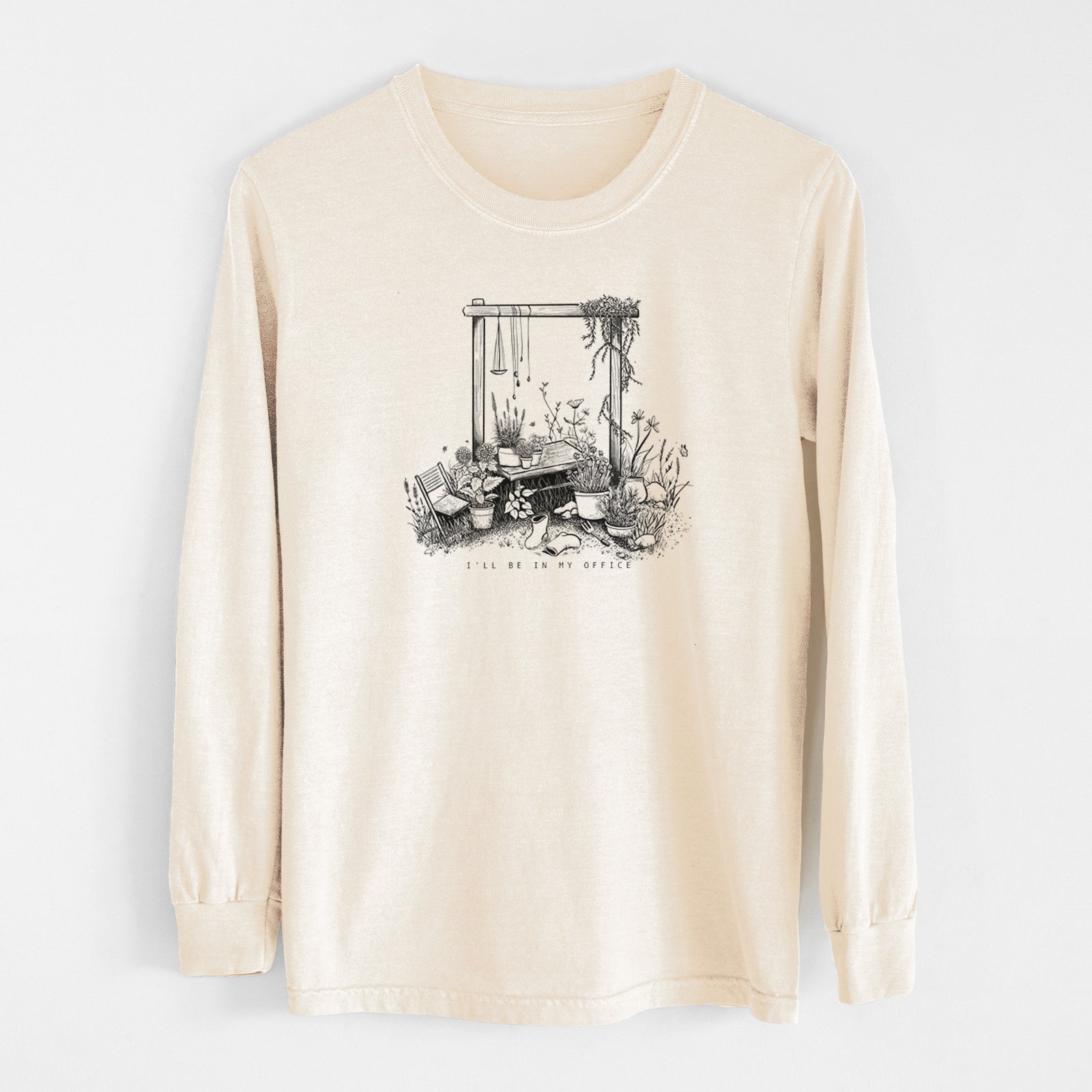 Ivory Comfort Colors long sleeve shirt laid flat, printed with a black ink illustration of a garden gate arch surrounded by potted plants and flowers.