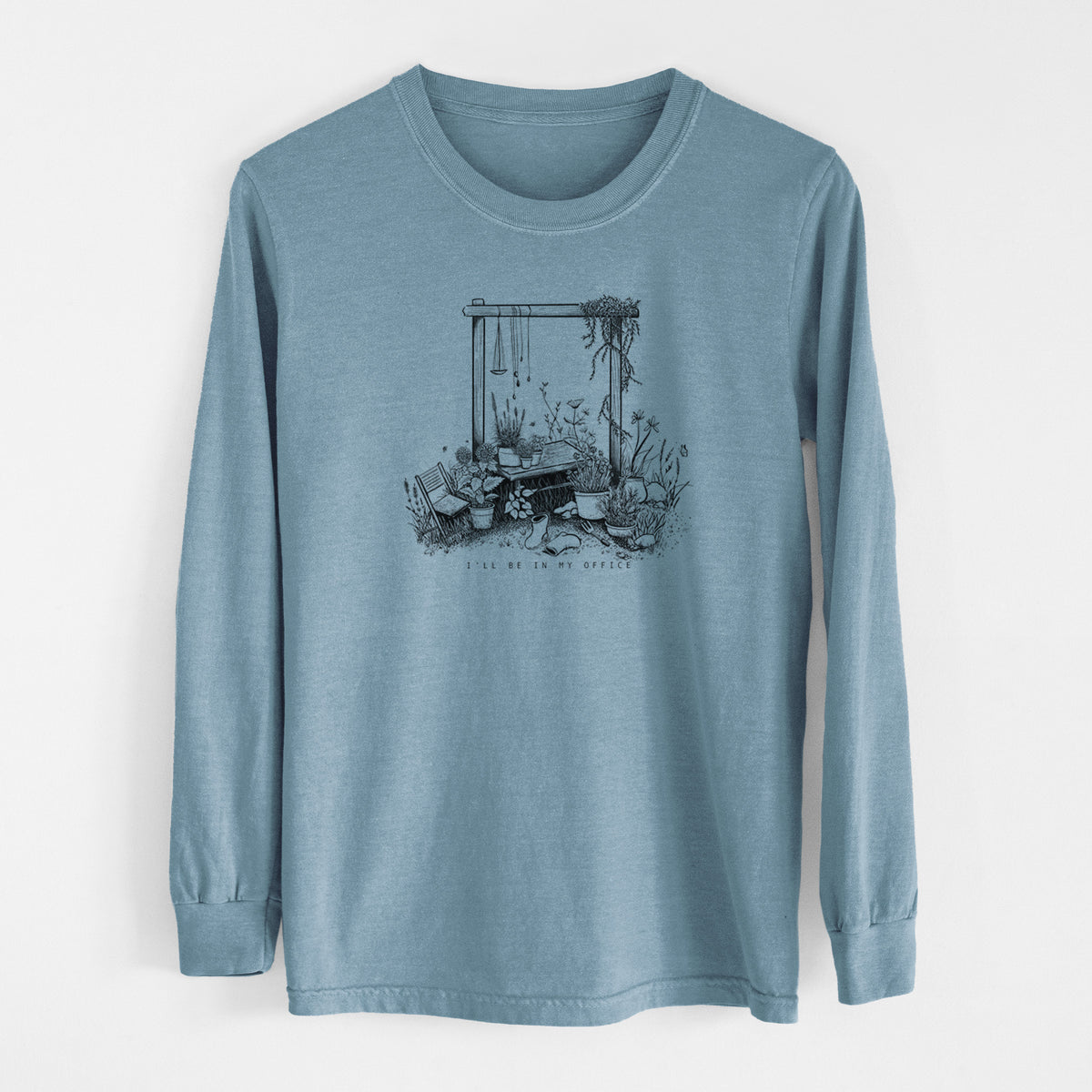 Steel blue Comfort Colors long sleeve shirt laid flat, printed with a black ink illustration of a garden gate arch surrounded by potted plants and flowers.