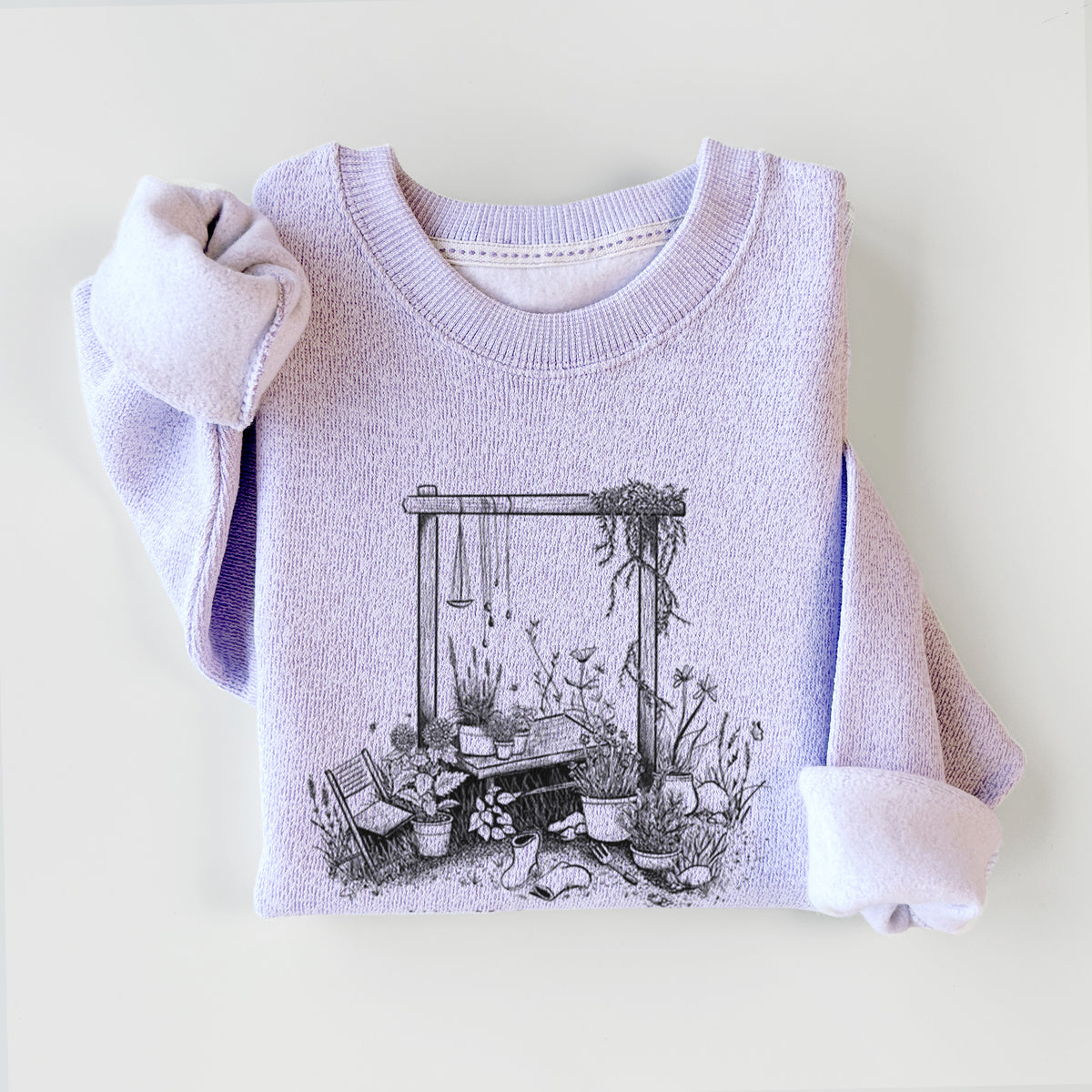 Ice purple knit sweatshirt printed with a black ink illustration of a garden gate arch surrounded by potted plants and flowers, styled flat.