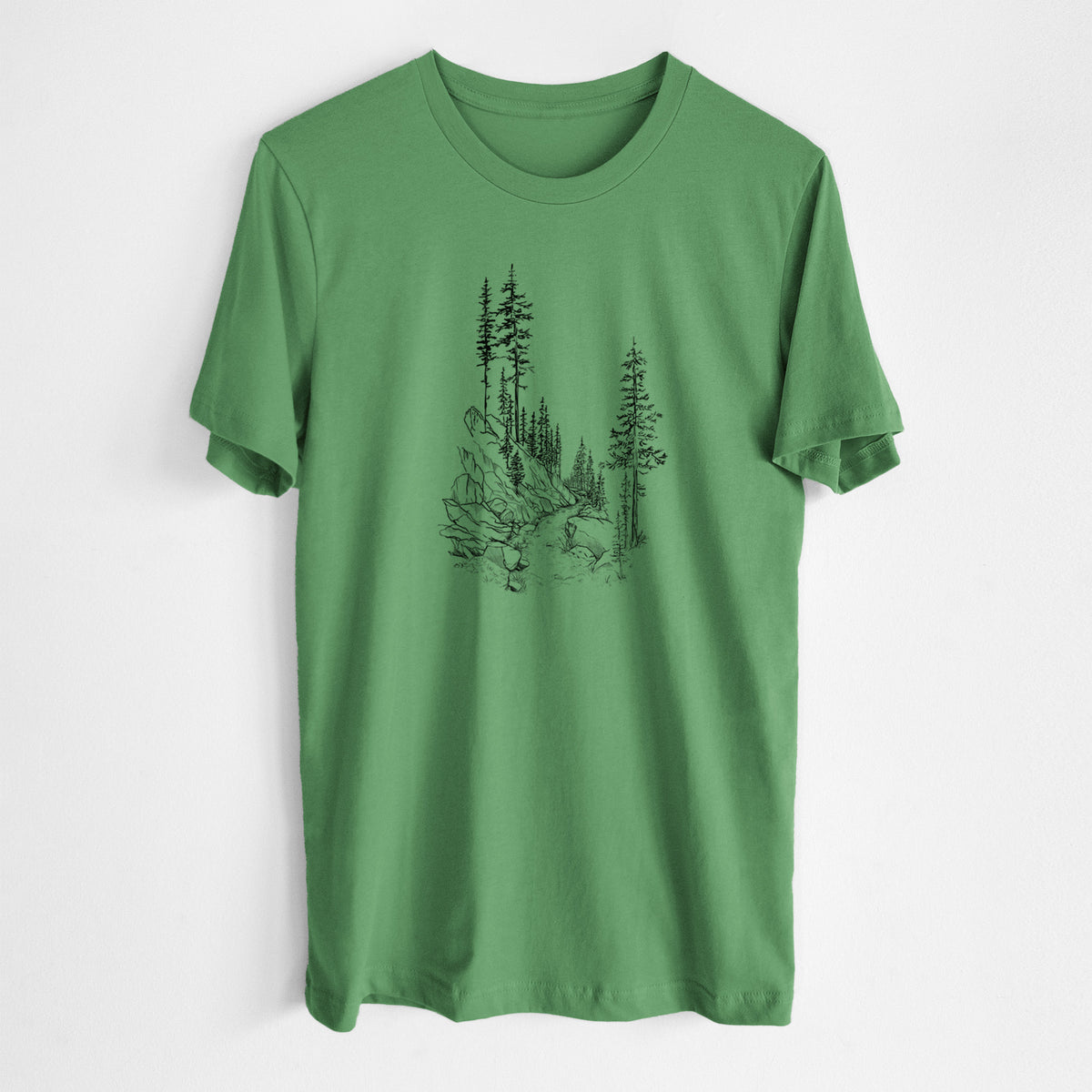 Leaf green lightweight cotton t-shirt laid flat, printed with a black ink illustration of a trail winding past tall pine trees and rocks into the woods.