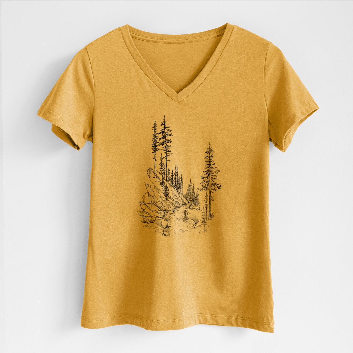 Honeycomb yellow women's relaxed fit cotton V-neck t-shirt laid flat, printed with a black ink illustration of a trail winding past tall pine trees and rocks into the woods.