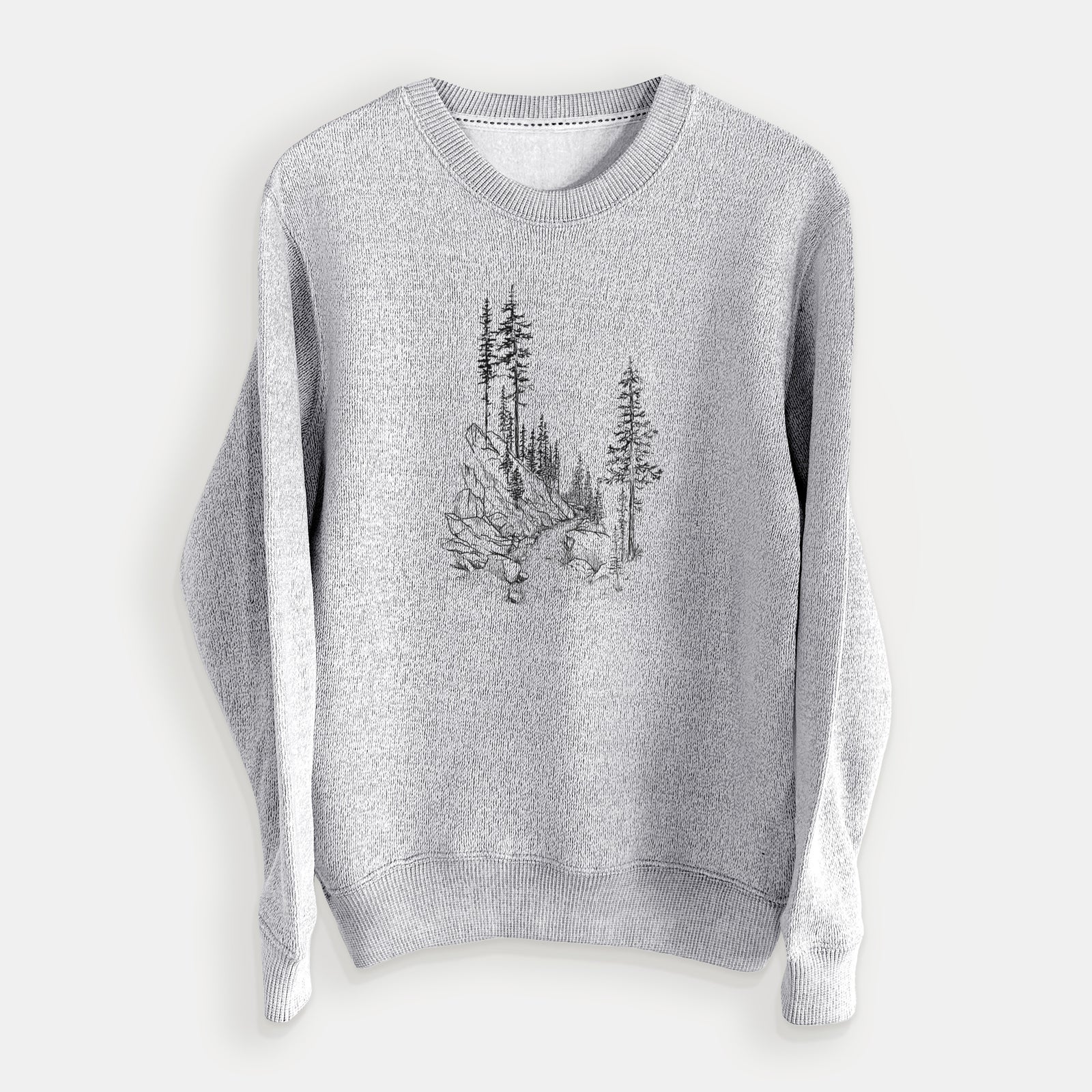 Salt and pepper knit sweatshirt laid flat, printed with a black ink illustration of a trail winding past tall pine trees and rocks into the woods.