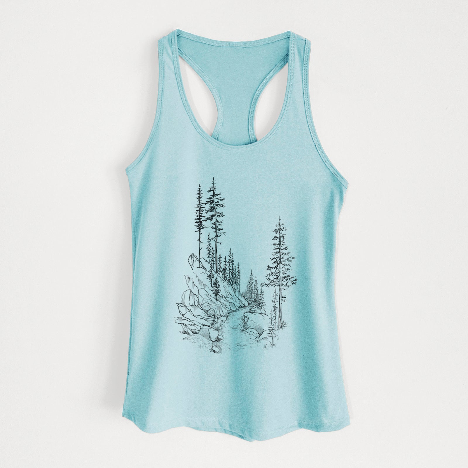 Banana cream women's racerback tank top laid flat, printed with a black ink illustration of a trail winding past tall pine trees and rocks into the woods.