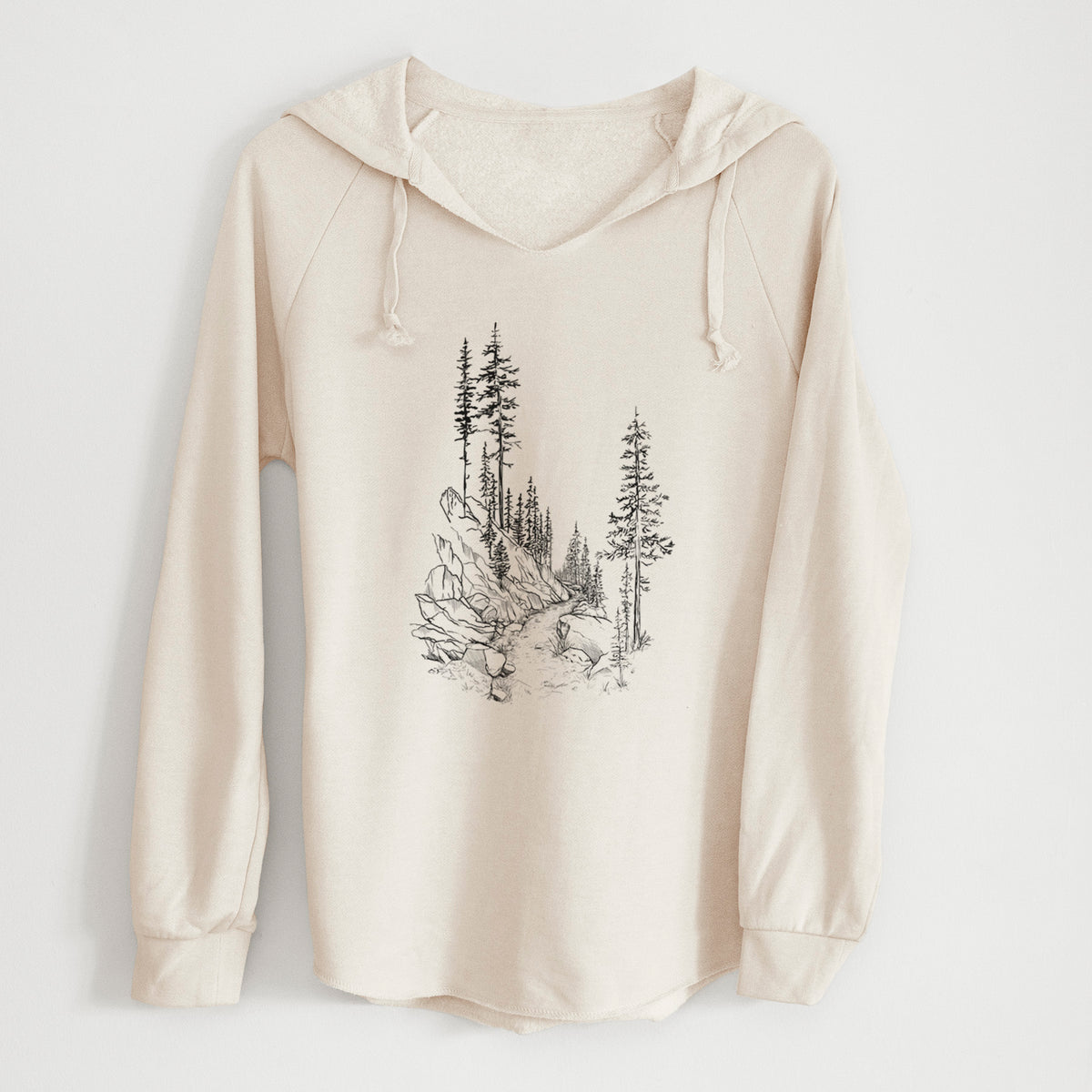 Bone cream women's Cali Wave hooded sweatshirt laid flat, printed with a black ink illustration of a trail winding past tall pine trees and rocks into the woods.