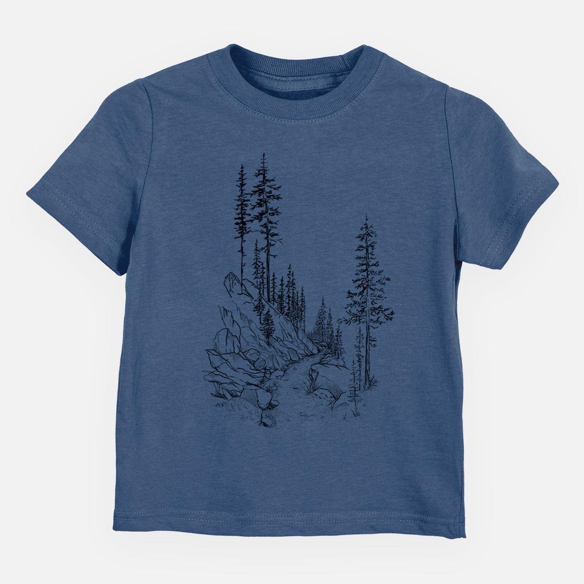 Indigo blue toddler t-shirt laid flat, printed with a black ink illustration of a trail winding past tall pine trees and rocks into the woods.