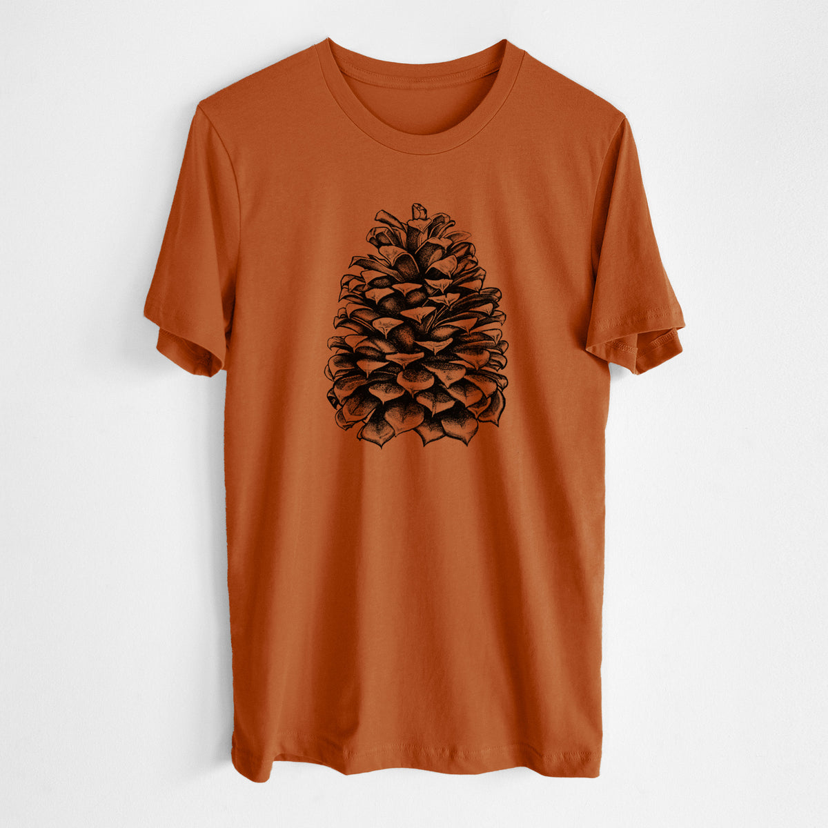 Autumn lightweight cotton t-shirt laid flat, printed with a detailed black ink illustration of a large Jeffrey pine cone.