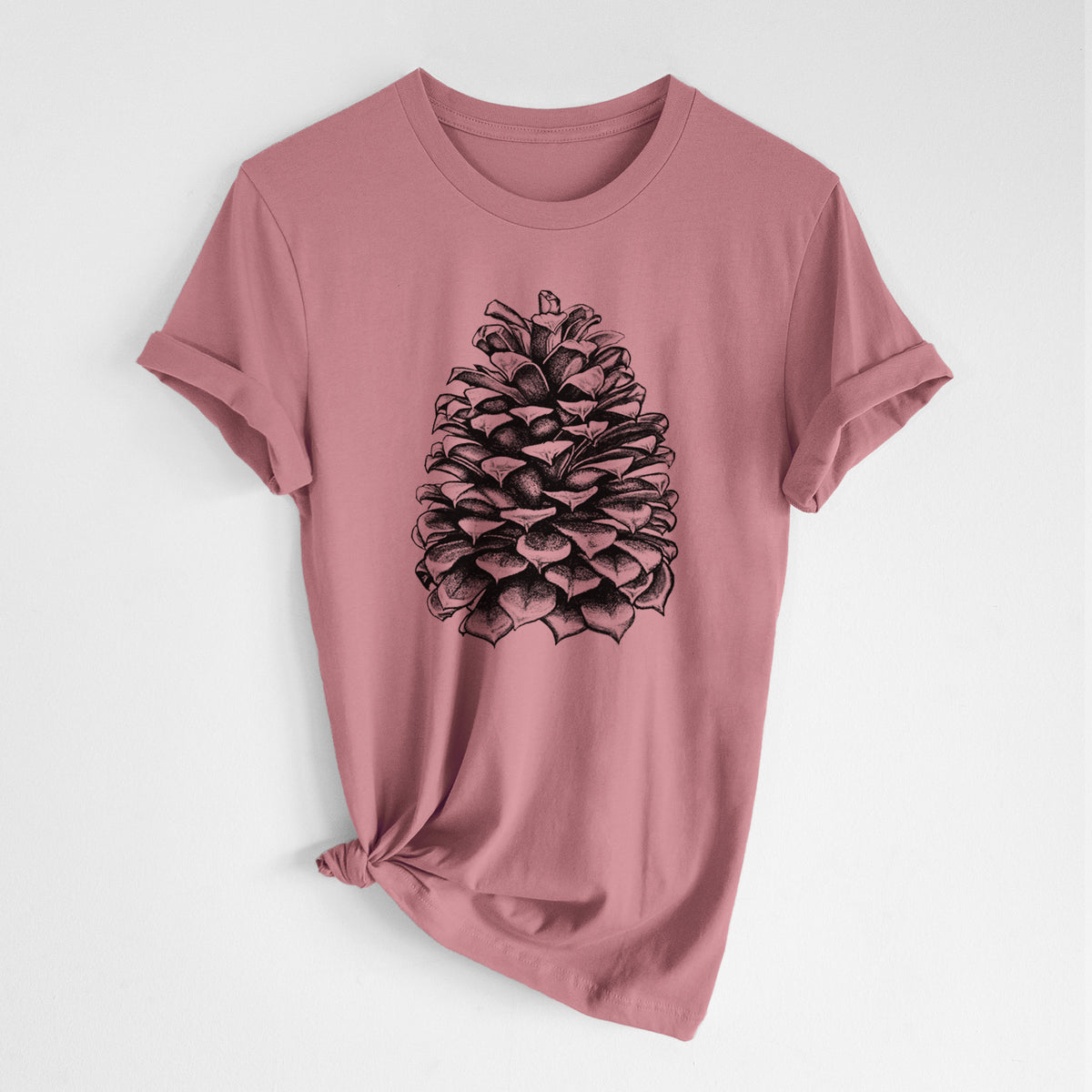 Mauve pink lightweight cotton t-shirt laid flat with the sleeves rolled, printed with a detailed black ink illustration of a large Jeffrey pine cone.