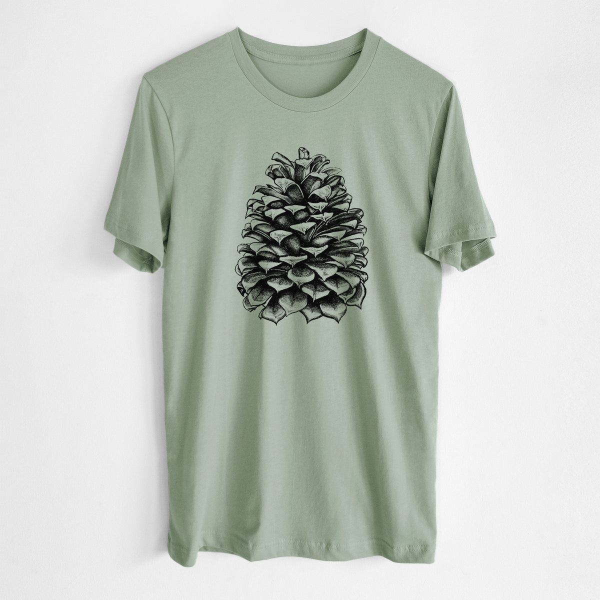 Sage green lightweight cotton t-shirt laid flat, printed with a detailed black ink illustration of a large Jeffrey pine cone.