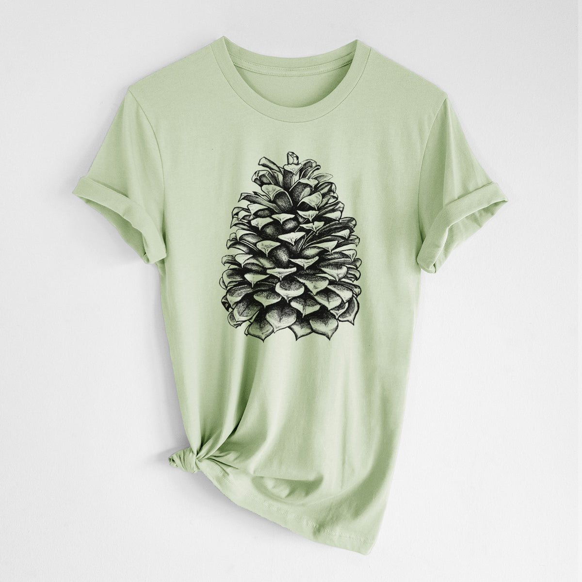 Spring green lightweight cotton t-shirt laid flat with the sleeves rolled, printed with a detailed black ink illustration of a large Jeffrey pine cone.