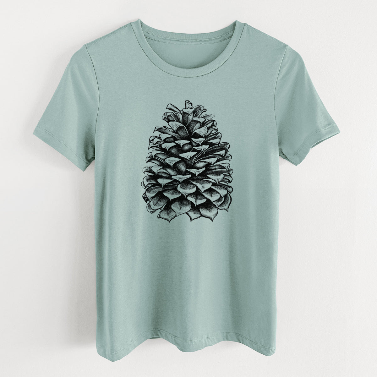 Dusty blue women's relaxed fit cotton t-shirt laid flat, printed with a detailed black ink illustration of a large Jeffrey pine cone.