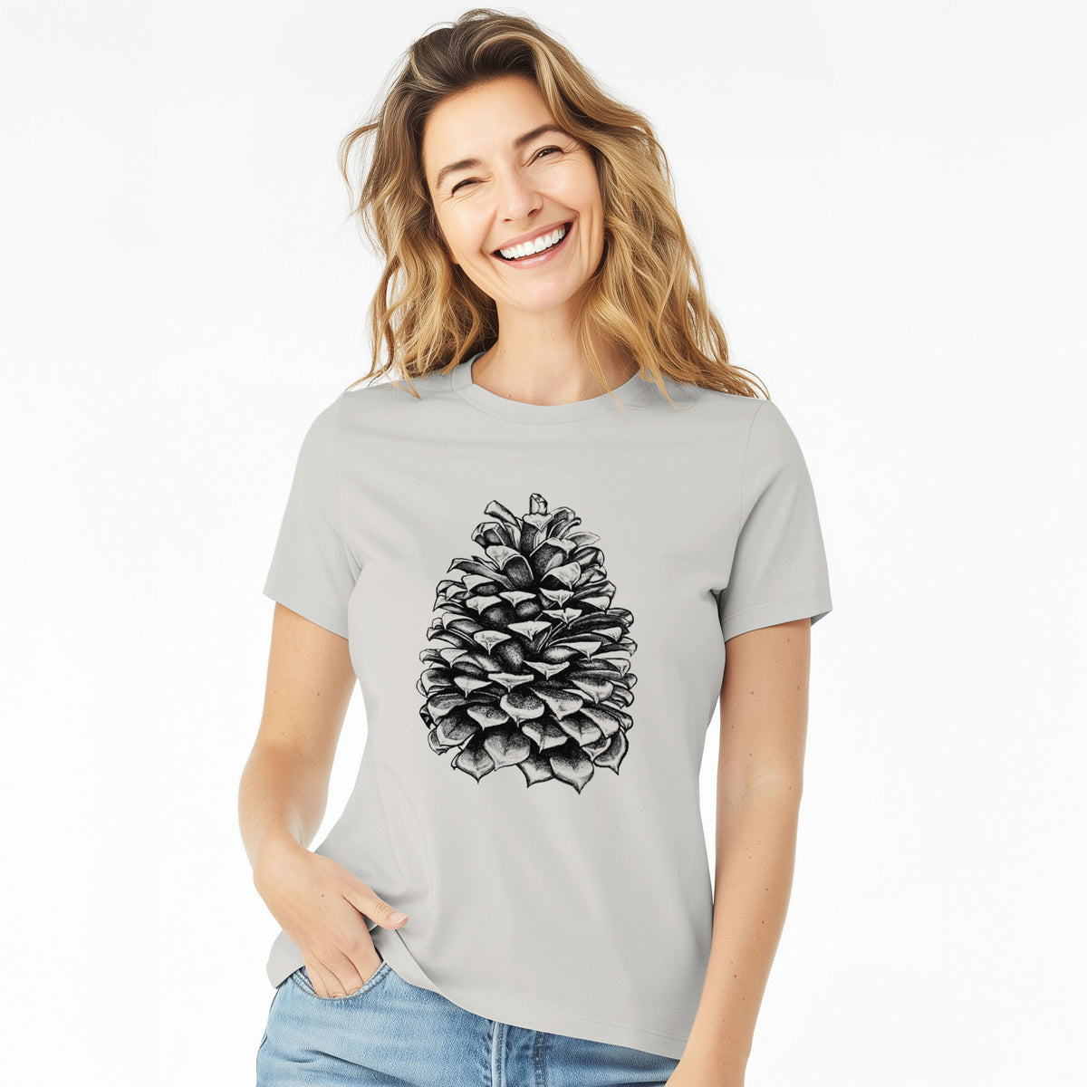 Woman wearing a lunar grey women's relaxed fit cotton t-shirt printed with a detailed black ink illustration of a large Jeffrey pine cone.
