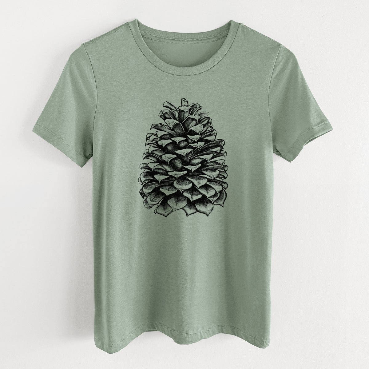 Sage green women's relaxed fit cotton t-shirt laid flat, printed with a detailed black ink illustration of a large Jeffrey pine cone.
