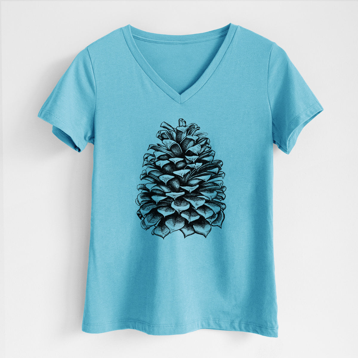 Turquoise women's relaxed fit cotton V-neck t-shirt laid flat, printed with a detailed black ink illustration of a large Jeffrey pine cone.