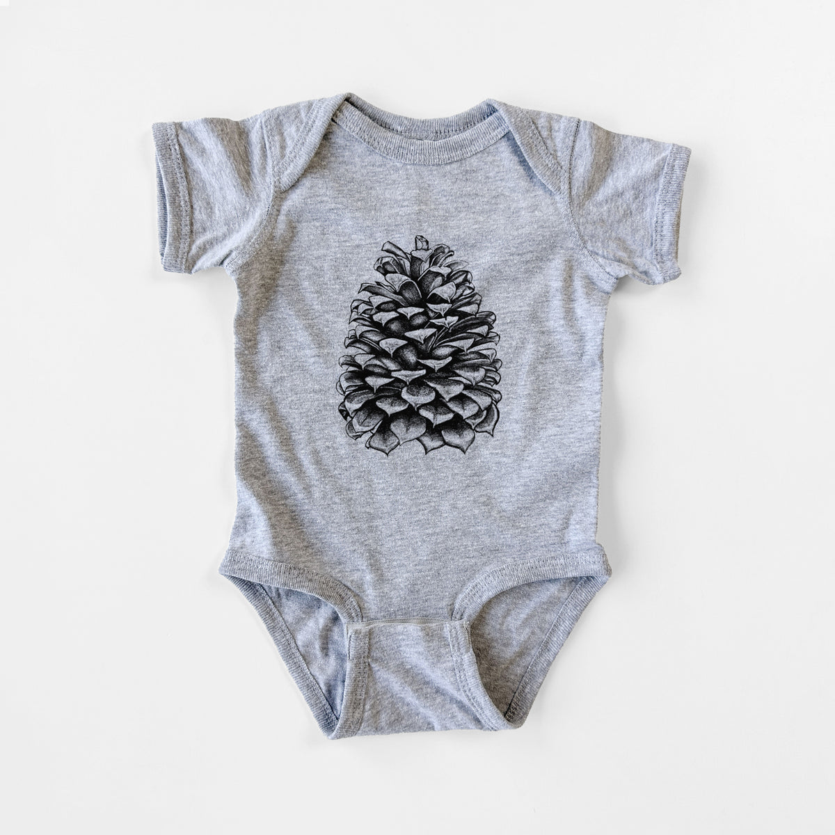 Grey baby bodysuit laid flat, printed with a detailed black ink illustration of a large Jeffrey pine cone.