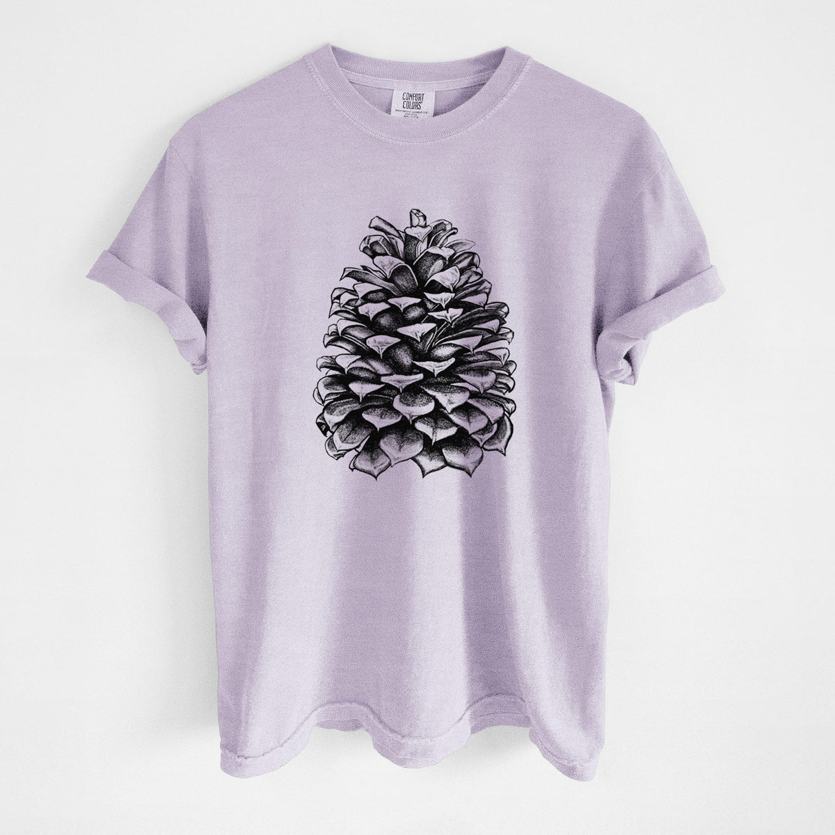 Orchid purple Comfort Colors t-shirt laid flat, printed with a detailed black ink illustration of a large Jeffrey pine cone.