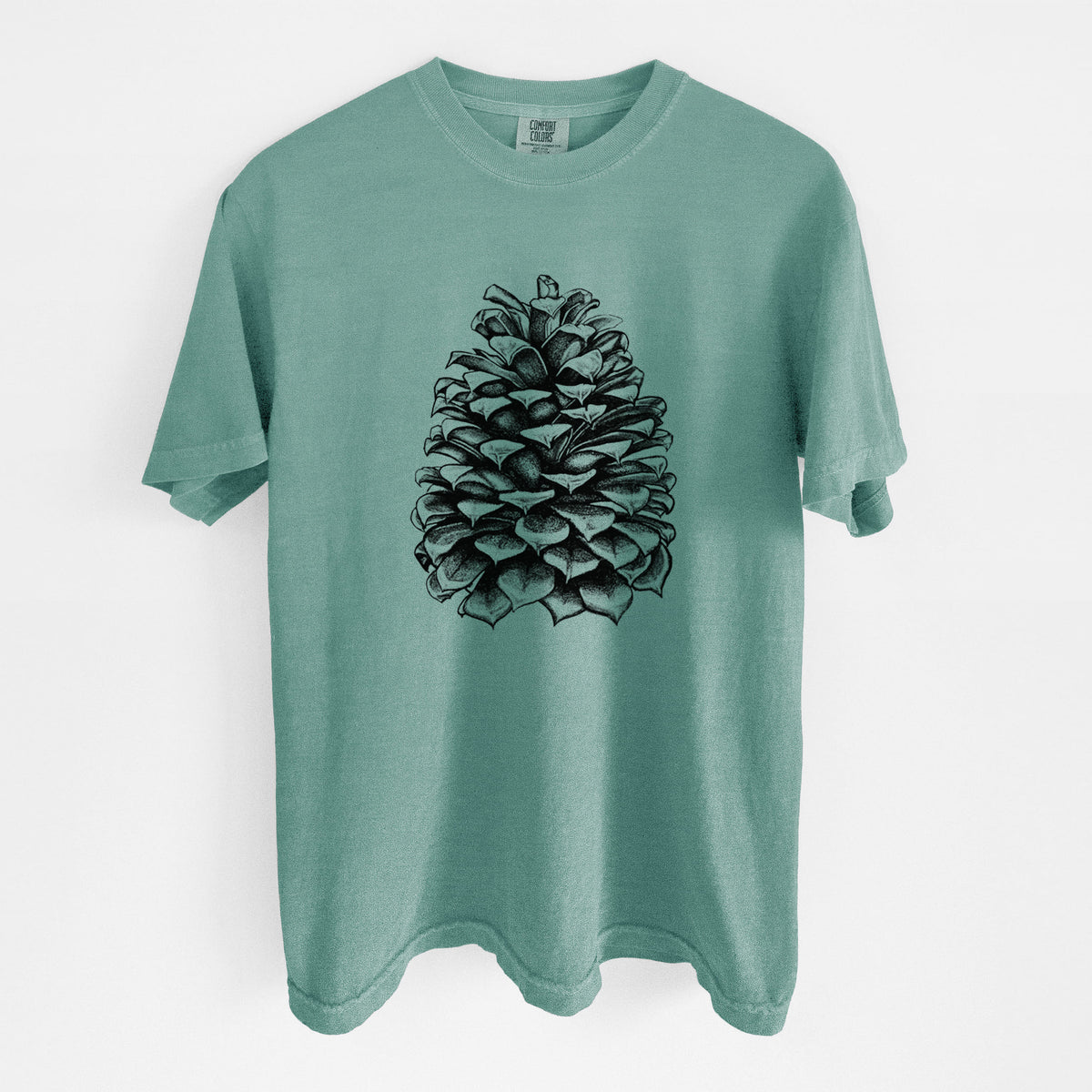 Reef green Comfort Colors t-shirt laid flat, printed with a detailed black ink illustration of a large Jeffrey pine cone.