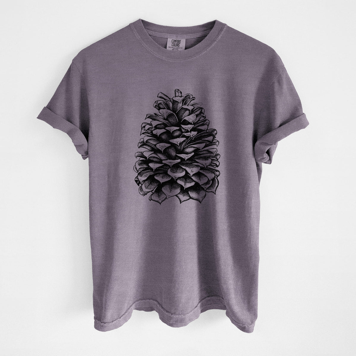 Wine red Comfort Colors t-shirt laid flat, printed with a detailed black ink illustration of a large Jeffrey pine cone.