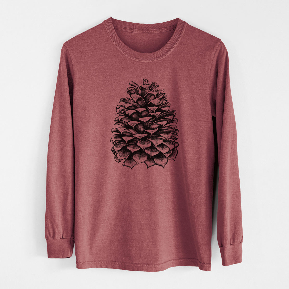 Brick red Comfort Colors long sleeve shirt laid flat, printed with a detailed black ink illustration of a large Jeffrey pine cone.