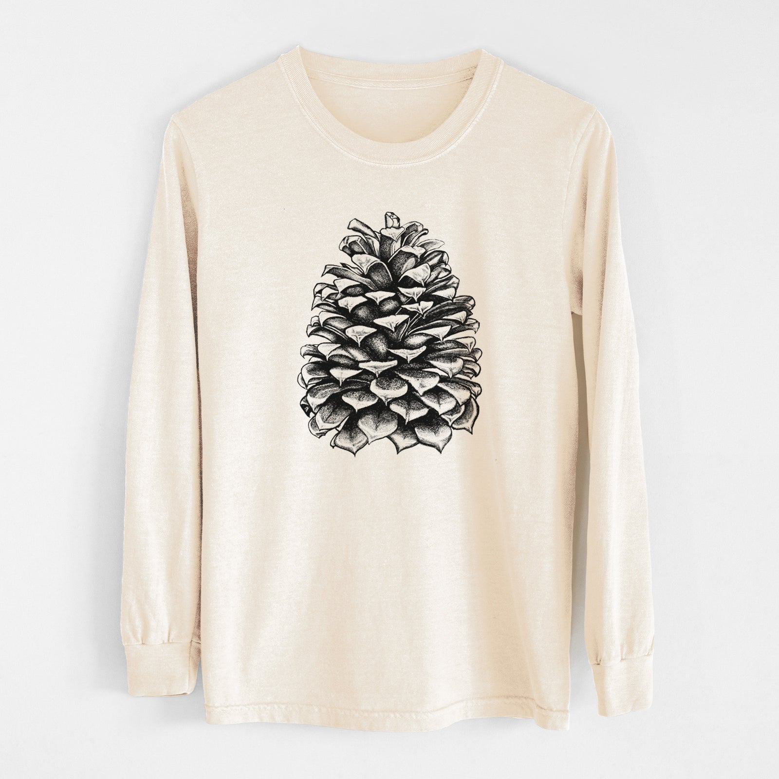 Ivory Comfort Colors long sleeve shirt laid flat, printed with a detailed black ink illustration of a large Jeffrey pine cone.