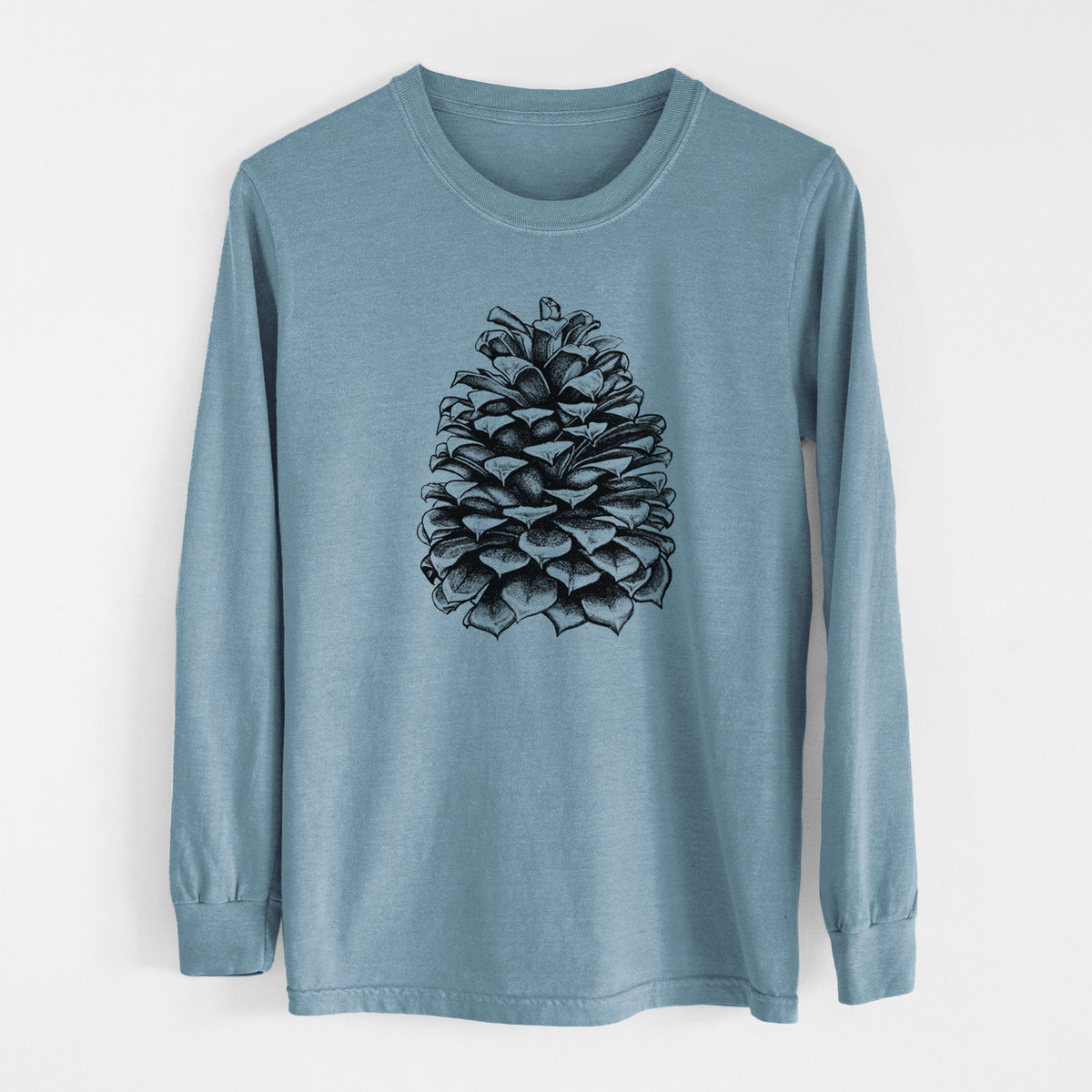 Steel blue Comfort Colors long sleeve shirt laid flat, printed with a detailed black ink illustration of a large Jeffrey pine cone.