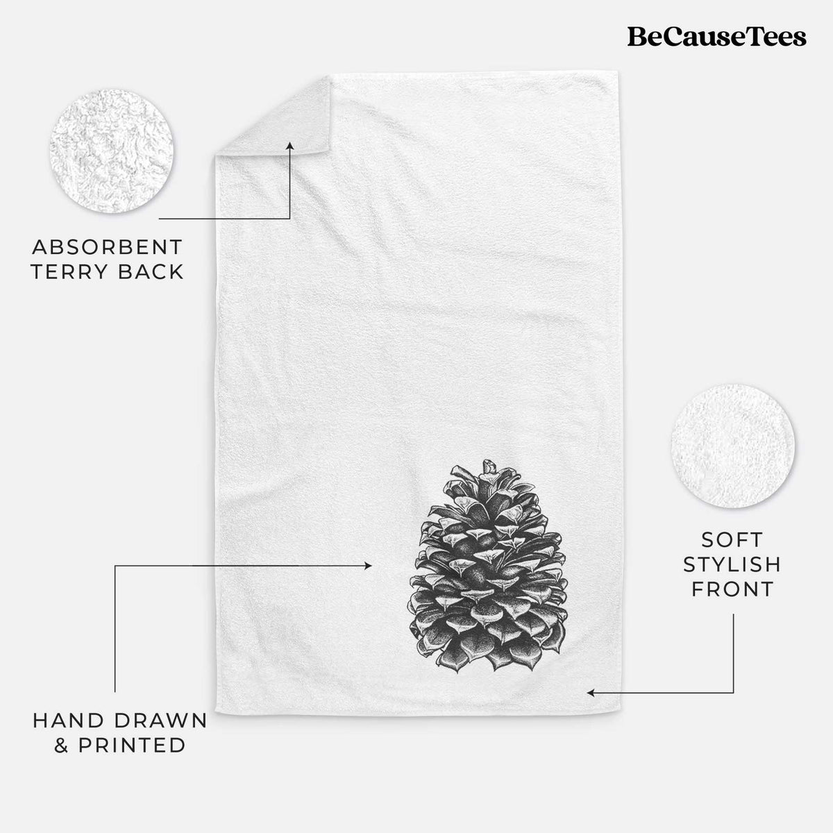 White hand towel printed with a detailed black ink illustration of a large Jeffrey pine cone.