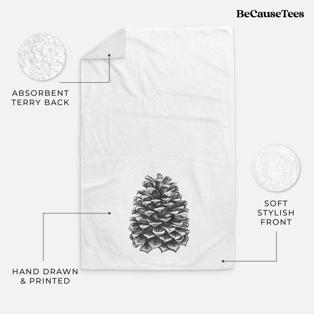 White hand towel printed with a detailed black ink illustration of a large Jeffrey pine cone.