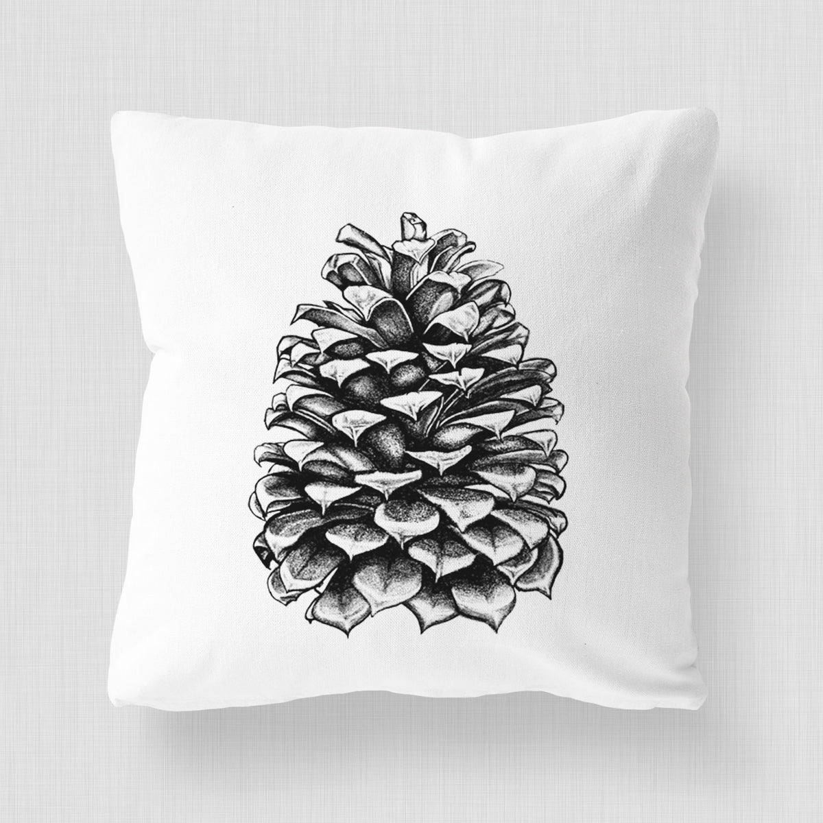 White pillow cover printed with a detailed black ink illustration of a large Jeffrey pine cone.