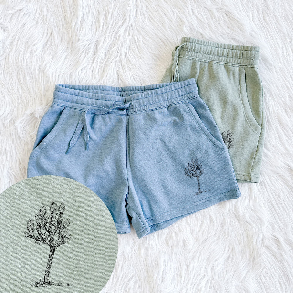 Two pairs of Cali Wave shorts in different colors printed with a detailed black ink illustration of a Joshua tree, with a close-up of the print.