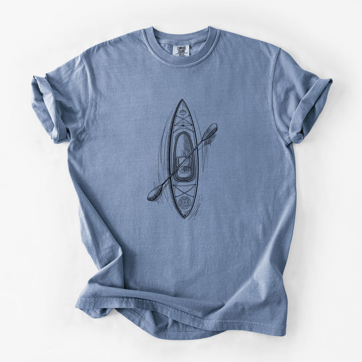 Blue jean Comfort Colors t-shirt laid flat, printed with a black ink illustration of a kayak with a paddle, seen from above.