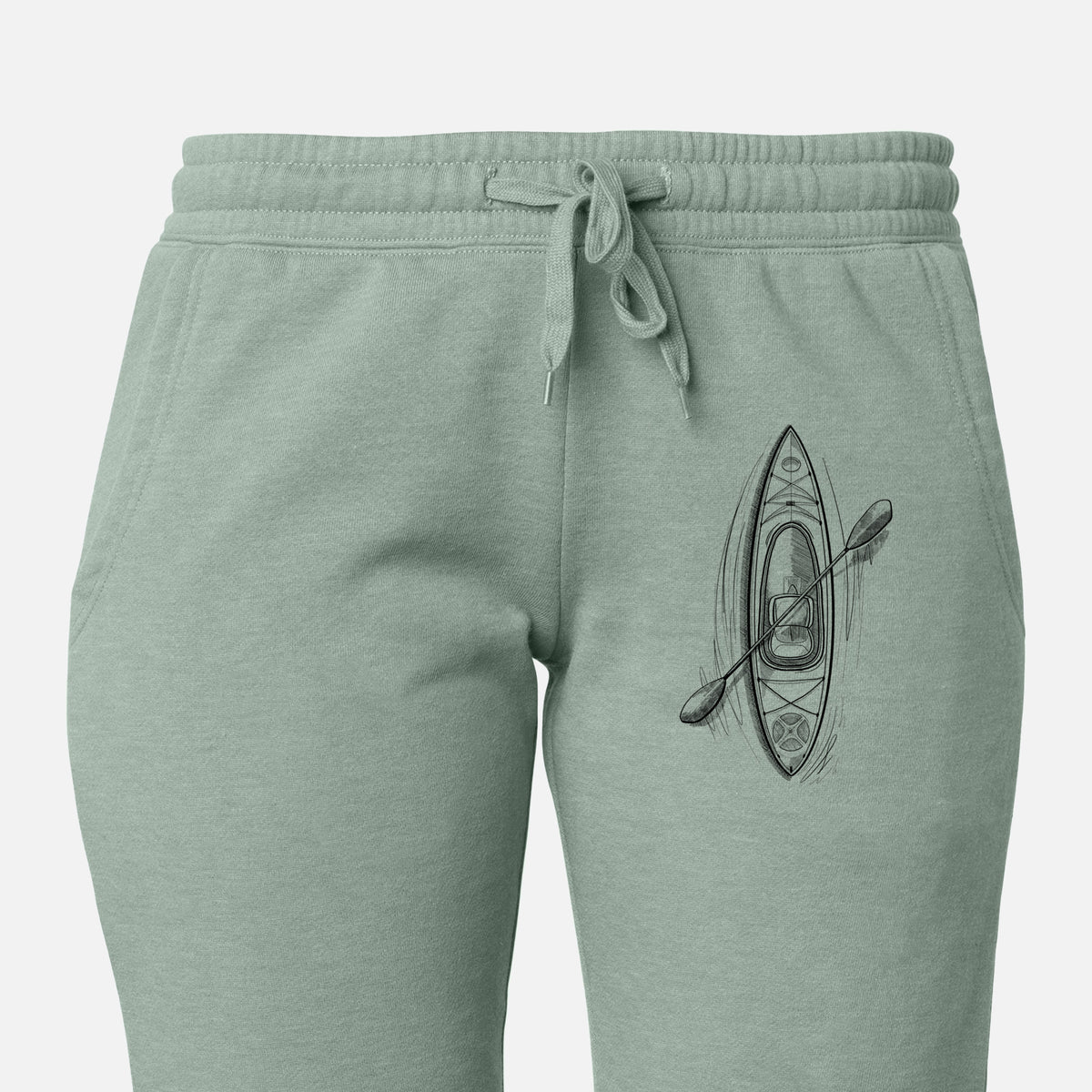 Front of sage green Cali Wave sweatpants, printed with a black ink illustration of a kayak with a paddle, seen from above on the leg.