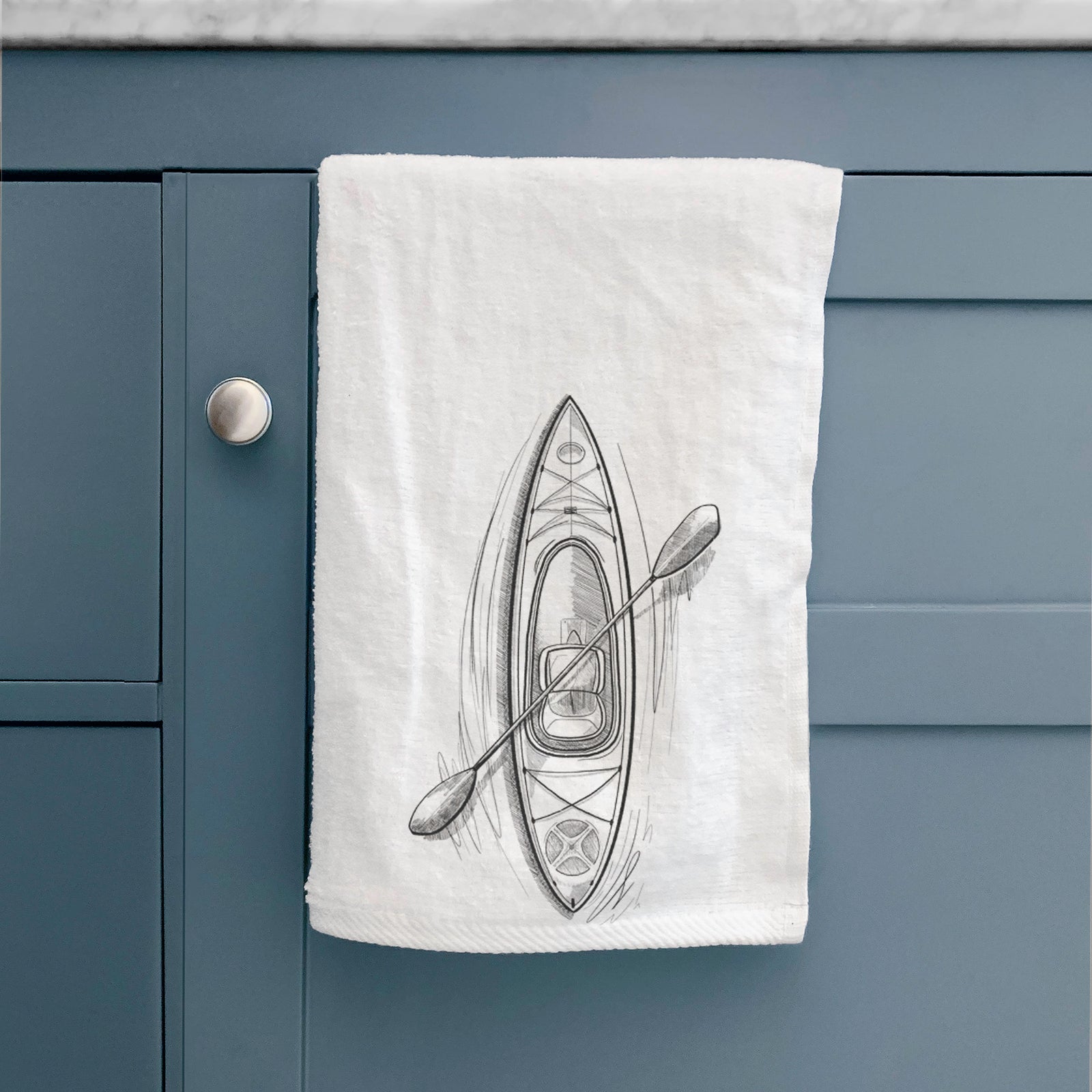 White hand towel printed with a black ink illustration of a kayak with a paddle, seen from above.