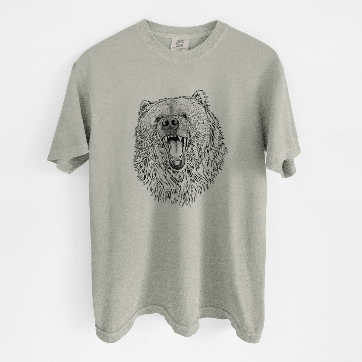 Sandstone beige Comfort Colors t-shirt laid flat, printed with a detailed black ink portrait of a roaring Kodiak bear facing forward.