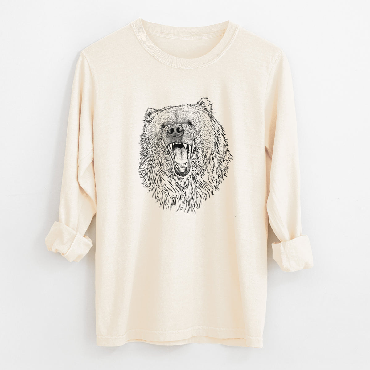Ivory Comfort Colors long sleeve shirt laid flat with the cuffs rolled, printed with a detailed black ink portrait of a roaring Kodiak bear facing forward.
