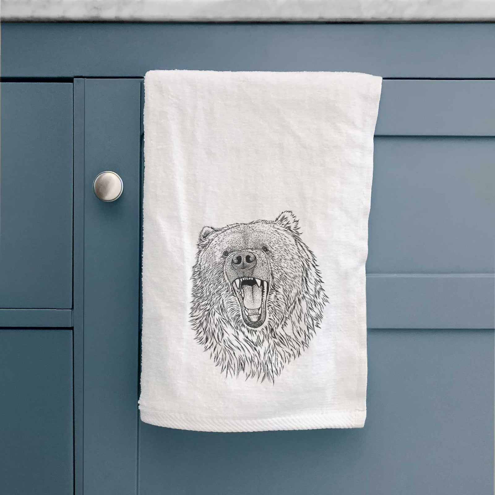 White hand towel printed with a detailed black ink portrait of a roaring Kodiak bear facing forward.