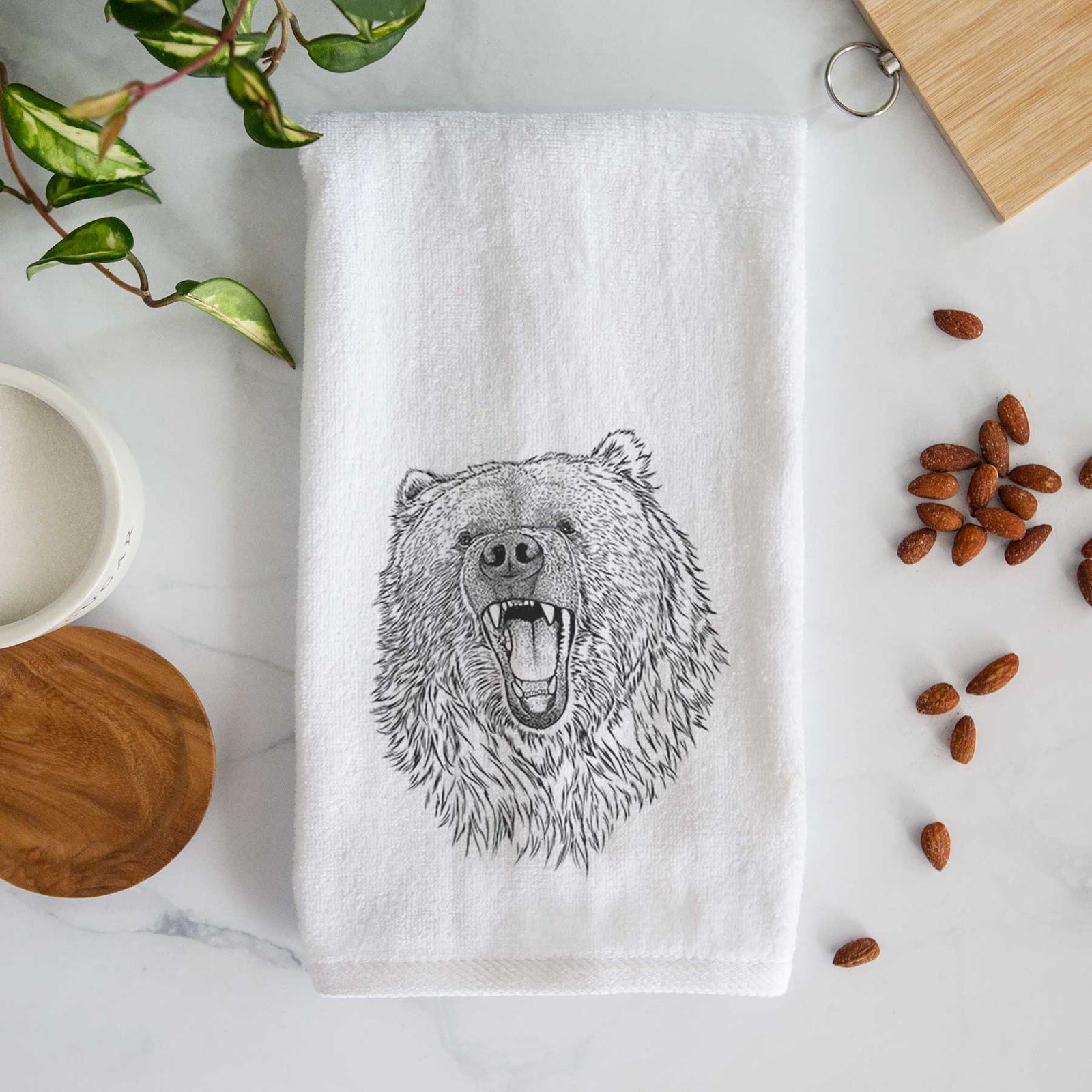 White hand towel printed with a detailed black ink portrait of a roaring Kodiak bear facing forward.