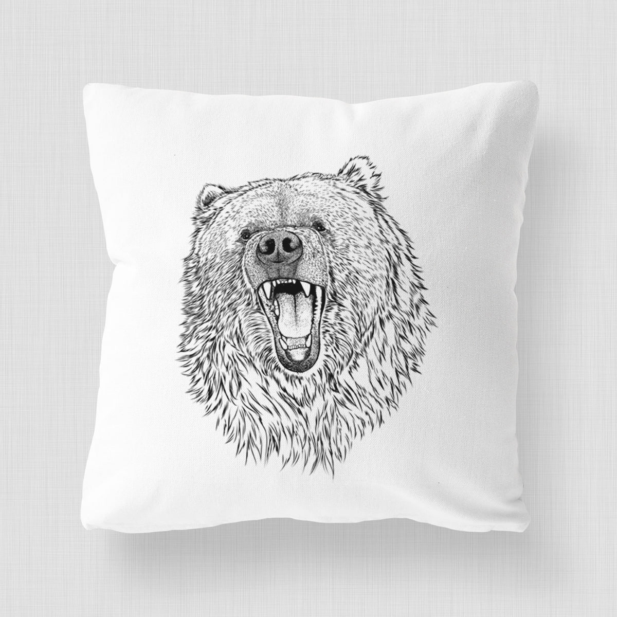 White pillow cover printed with a detailed black ink portrait of a roaring Kodiak bear facing forward.