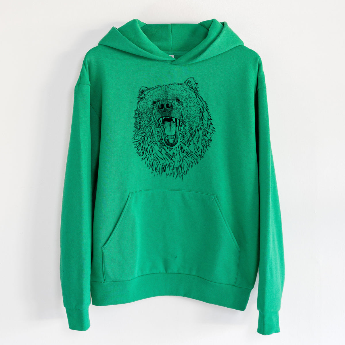 Ursus arctos - Kodiak Bear - Statement Midweight Hoodie in Kelly Green, hanging on a white wall, with a front kangaroo pocket and no drawcords.