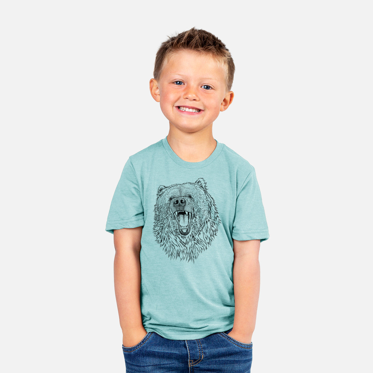 Smiling boy wearing a youth t-shirt printed with a detailed black ink portrait of a roaring Kodiak bear facing forward.