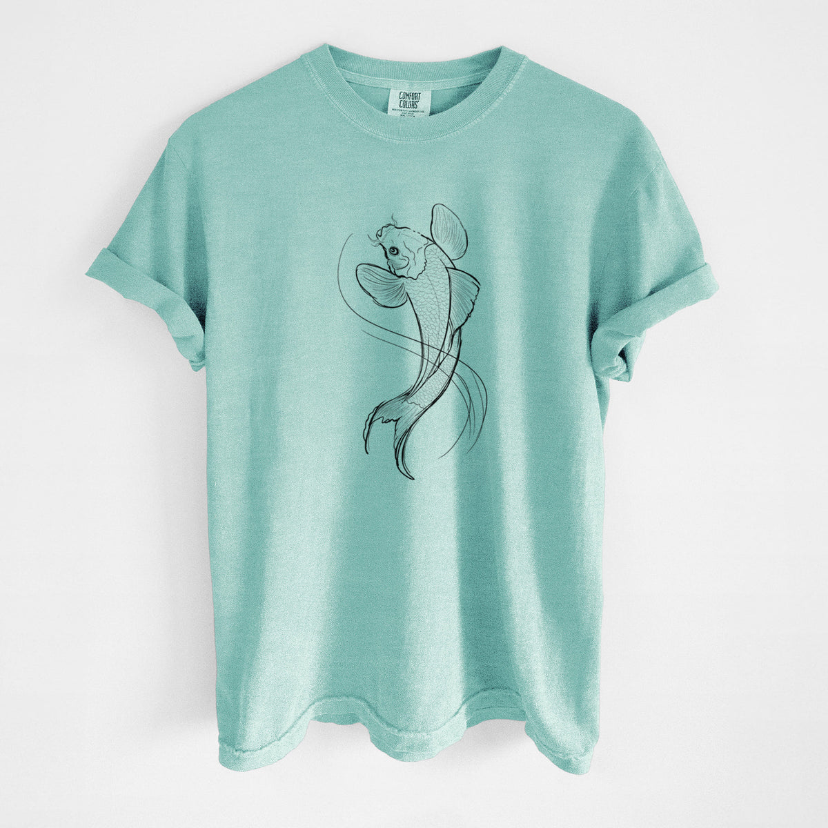 Chalky mint Comfort Colors t-shirt laid flat, printed with a black ink line drawing of a koi fish swimming with flowing fins.