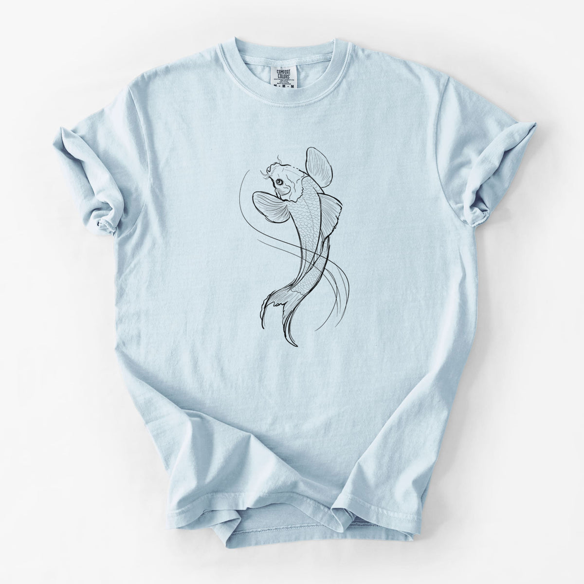 Chambray blue Comfort Colors t-shirt laid flat, printed with a black ink line drawing of a koi fish swimming with flowing fins.